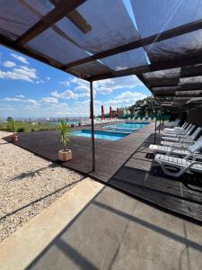 a view of a swimming pool with chairs and a patio at Комплекс Тополица -The beautiful view in Aytos