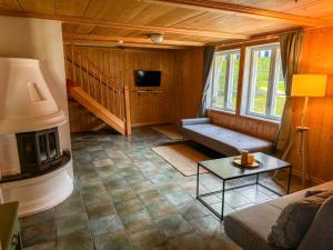 a living room with a couch and a tv at Stugan in Ekshärad