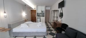 a small bedroom with a bed and a kitchen at Casa Tua in Kalamata