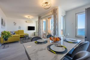 a living room with a table and chairs and a couch at Klara in Crikvenica