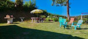 a group of chairs and a table and an umbrella at Petite maison in Planchez