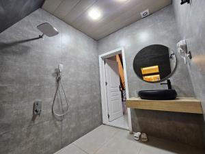 a bathroom with a sink and a mirror at Aframe Park Qebele in Gabala +3 photos