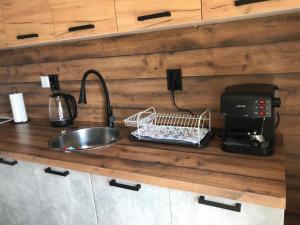a kitchen counter with a sink and a coffee maker at Boutique house in Devin +26 photos