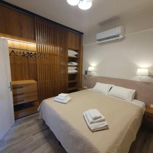 a bedroom with a bed with towels on it at Casa di Bello in Arkoudi +9 photos