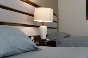 a bedroom with a bed and a lamp on a table at Infinity Suites doble room 102 in Cancún
