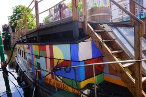 a colorful boat with a staircase on the side of it at Schute "Kunstkudder" im Hansehafen in Stade