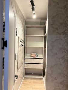 a walk in closet in a bathroom with a door at Культегин 14 in Taldykolʼ +1 photo