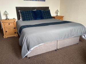 a bedroom with a large bed and two night stands at Harbour bridge, Camps bar in Wick