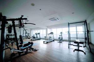 a gym with several tread machines in a room at Apartemen Grand Kamala Lagoon by JVT PRO in Pekayon Satu
