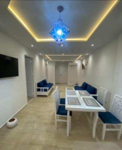 une salle à manger avec une table et des chaises bleues dans l'établissement ResidenceHbiba, à Ḩammām al Ghazzāz 7 autres photos