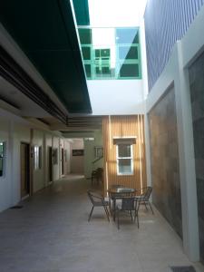 an empty hallway of a building with chairs and a table at Karas Pension House East in Tuguegarao City