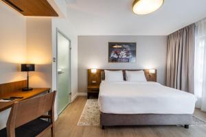 Postel nebo postele na pokoji v ubytování Hotel Opera