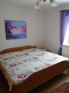 a bedroom with a bed with a quilt on it at Ferienwohnung Moni in Kitzscher