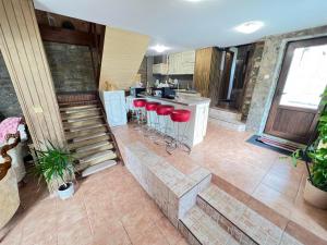 an aerial view of a kitchen with red bar stools at The 3 Pines GuestHouse - Трите Бора in Dryanovo