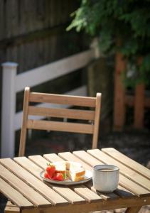 a plate of bread and fruit on a wooden table at Newly Refurbished 2-Bed with Patio, Netflix & Wi-Fi in Worksop