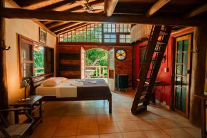 a bedroom with a bed and a ladder in a room at Paraty Paradiso in Parati-Mirim +88 photos