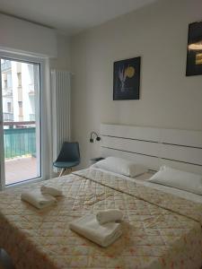 a bedroom with a large bed with two pillows on it at Bergamo Rooms 1 & 2 in Bergamo
