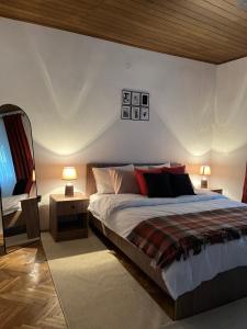 a bedroom with a bed and two lamps and a mirror at Villa Lena in Ohrid