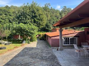 a patio with a table and chairs next to a building at Casa Romeo in Brion