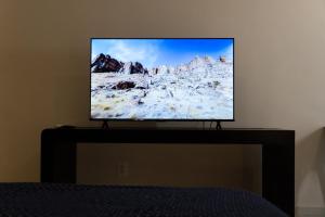 a flat screen tv sitting on top of a table at Infinity Suites single room 104 in Cancún