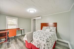 a bedroom with a bed and a desk in it at Lake Guntersville Home 1 Mi to Boat Ramp! in Guntersville