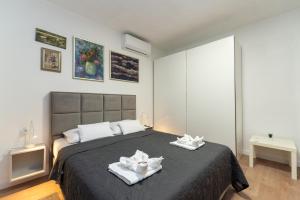 a bedroom with a large bed with two towels at Beachfront amazing sunset house in Rovanjska +16 photos