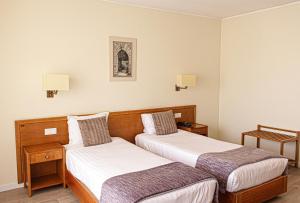 a hotel room with two beds and two lamps at Hotel dos Loios in Santa Maria Da Feira +73 photos