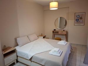 a bedroom with a bed with towels on it at Sandy's house in Ioannina