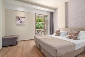 Postelja oz. postelje v sobi nastanitve Ammon Zeus Luxury Beach Hotel