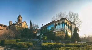 a building with a clock tower on top of it at Vinotel Boutique Hotel in Tbilisi City