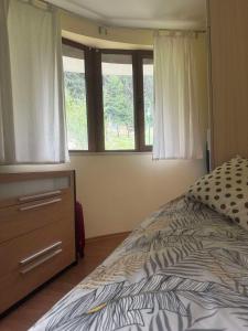 A bed or beds in a room at Ski Area 202 apt, The Castle 1, Pamporovo