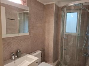 a bathroom with a shower and a sink and a toilet at Sandy's house in Ioannina