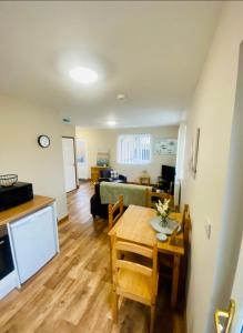 a living room with a table and a couch at Lilly Cabin with Hot Tub in York