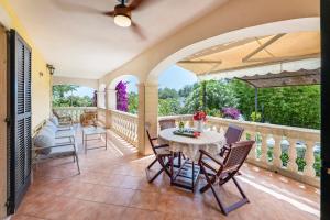 an outdoor patio with a table and chairs at VILLA JACELIA in Sa Pobla