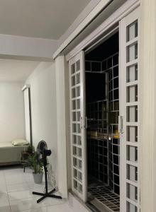 a room with a sliding glass door with a window at Loft no centro de Araxá in Araxá