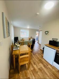 a kitchen and a living room with a table and a kitchen at Tulip Cabin with Hot Tub in York