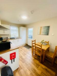 a kitchen and dining room with a wooden table and a kitchen and a dining room at Tulip Cabin with Hot Tub in York