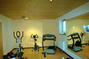 a gym with treadmills and exercise bikes in a room at Residence Kramhuter in Sesto