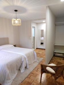 a bedroom with a bed and a chair and a piano at Fonteculler in Fonte Culler