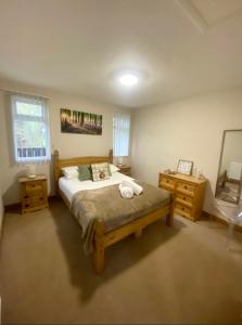 a bedroom with a large bed and two night stands at Cherry Cabin with Hot Tub in York