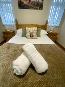 a bedroom with two white socks on a bed at Cherry Cabin with Hot Tub in York