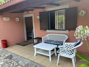 two chairs and a table on a patio at Casa Dos Caseiros in Brion