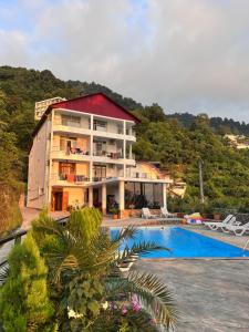un edificio con piscina accanto a un resort di Zuri Kvariati a Kvariati