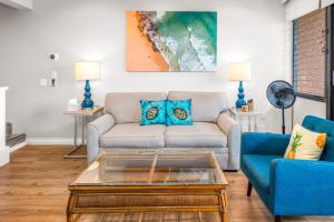 a living room with a couch and a coffee table at Updated 2bd 2ba Maui Vista Condo with Ocean View in Kihei +42 photos