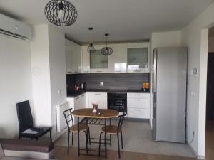 a kitchen with a table and chairs in a room at Apartment Rosa in Varaždin