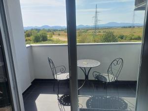 a balcony with a table and chairs and a view at Apartment Rosa in Varaždin