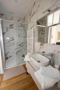 a white bathroom with a shower and a sink at Le Repaire in Montigny-le-Gannelon +25 photos