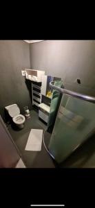 a bathroom with a toilet and a glass shower at ÇANKAYA BOUTiQUE HOTEL in Bahçelievler