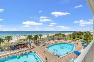 a view of the pool and beach from the balcony of a resort at Sunset at Summit in Panama City Beach
