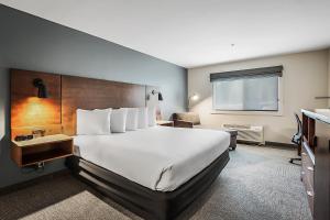 a hotel room with a large bed and a desk at Third Street Inn in McCall +38 photos